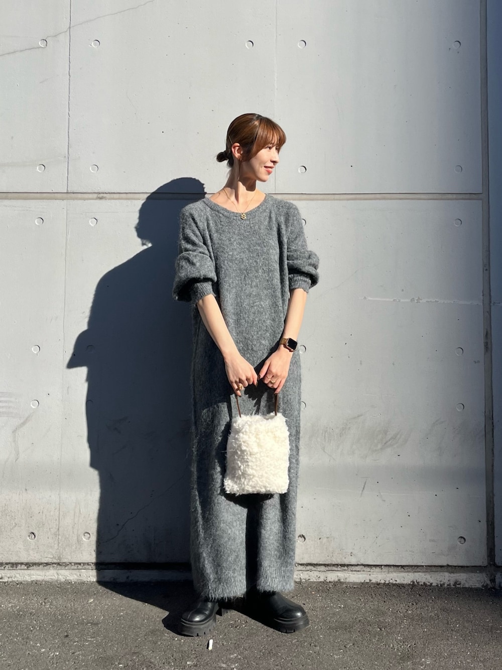 ホワイト系のハンドバッグ、グレー系のワンピースを着用したレディースの秋コーディネートの2枚目の写真
