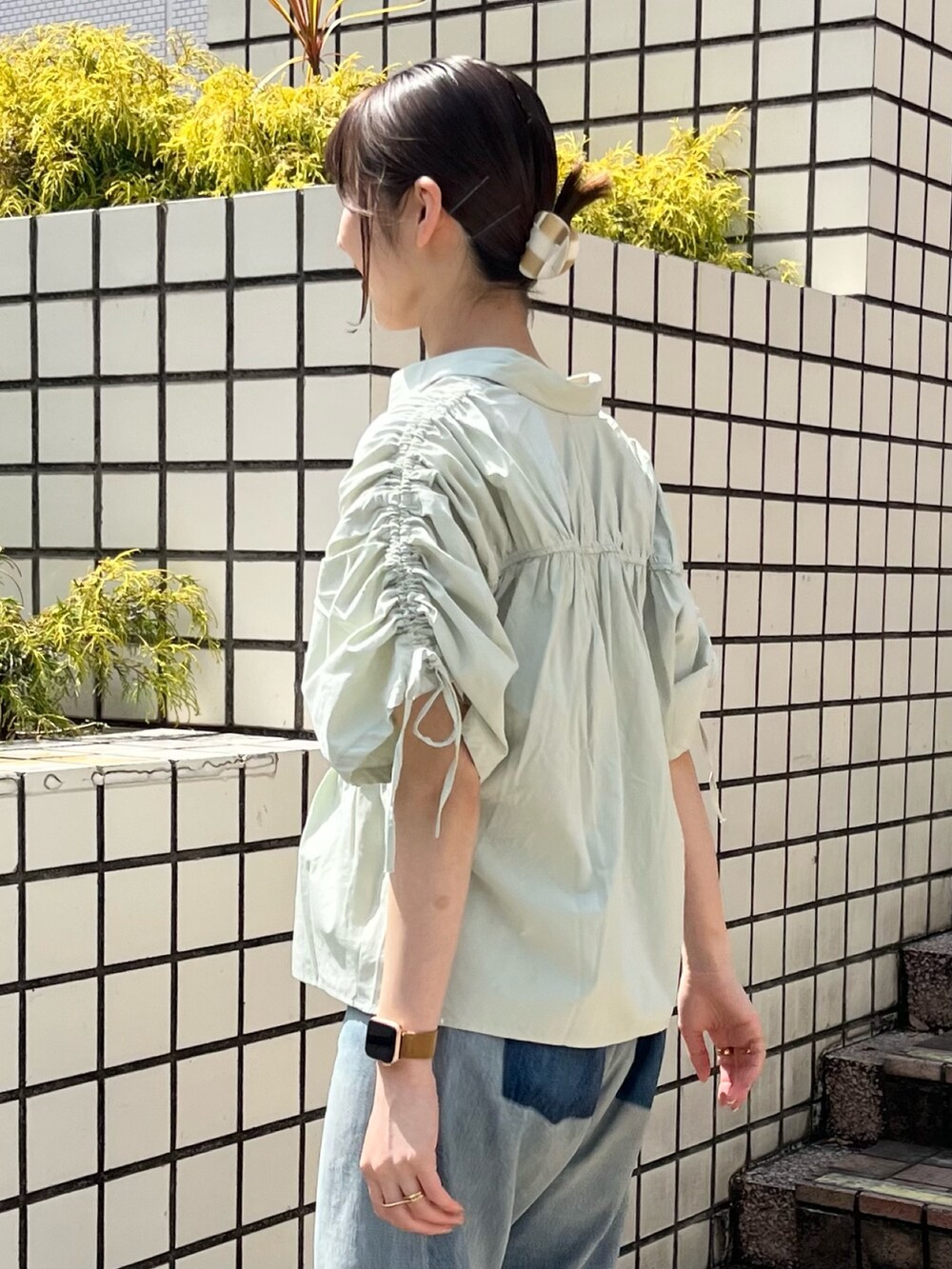 グリーン系のシャツ/ブラウス、ブルー系のデニムパンツを着用したレディースの春コーディネートの4枚目の写真