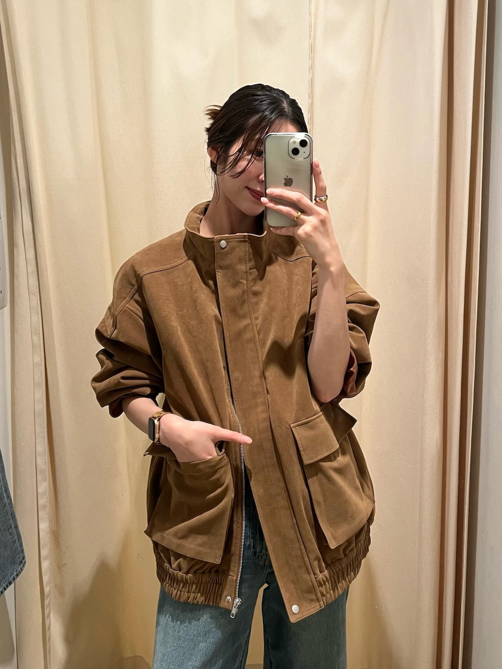 ブルー系のデニムパンツ、ブラウン系のブルゾンを着用したレディースの秋コーディネートの4枚目の写真