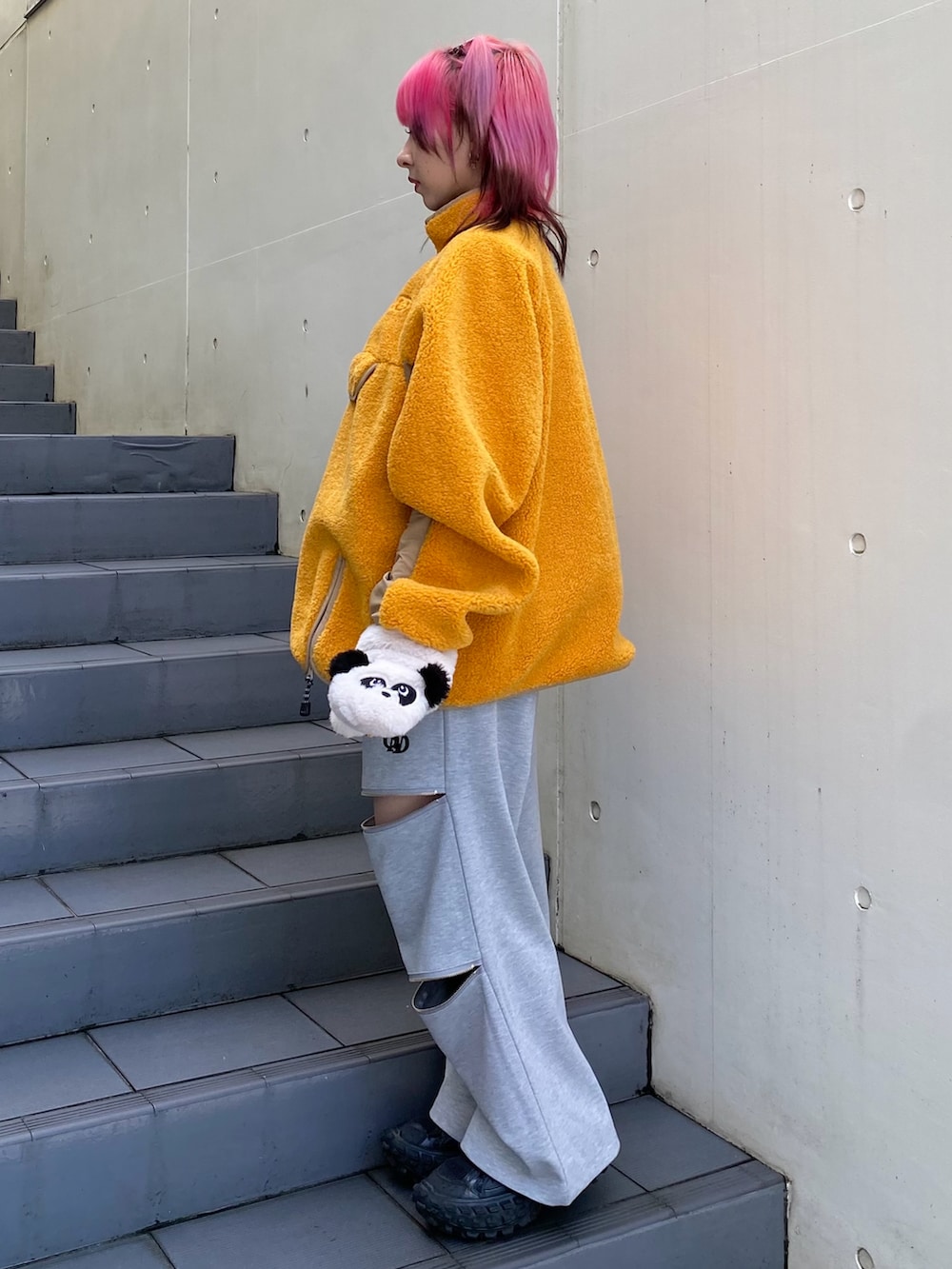 オレンジ系のその他トップス、グレー系のその他パンツ、ホワイト系の手袋を着用したレディースの秋コーディネートの4枚目の写真