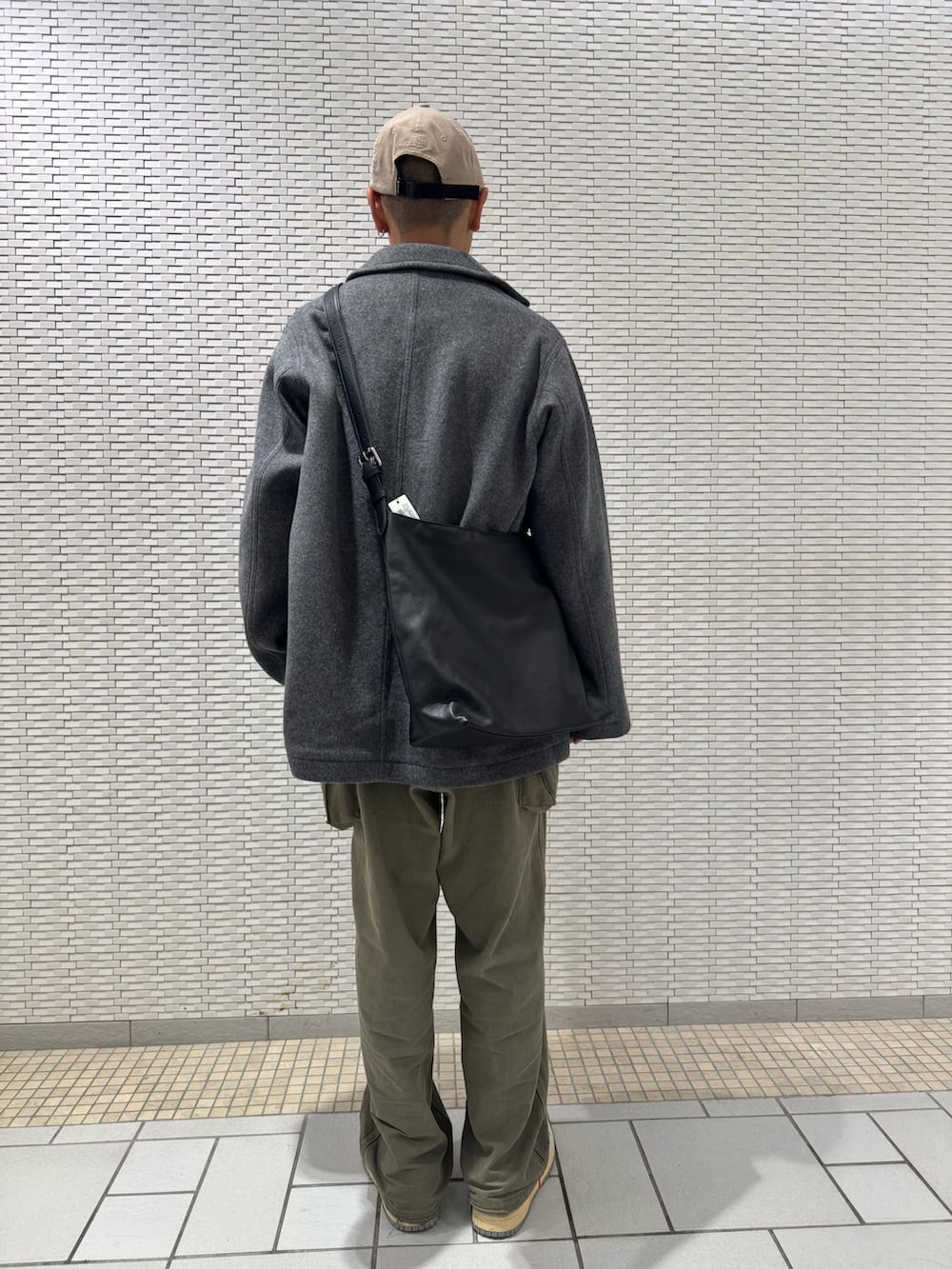 グレー系のテーラードジャケット、ベージュ系のキャップを着用したメンズの秋コーディネートの4枚目の写真