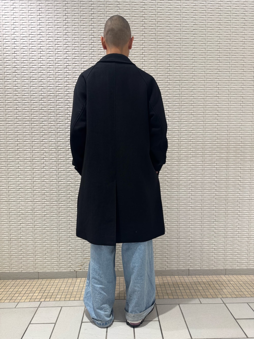 ブラック系のステンカラーコートを着用したメンズの冬コーディネートの3枚目の写真