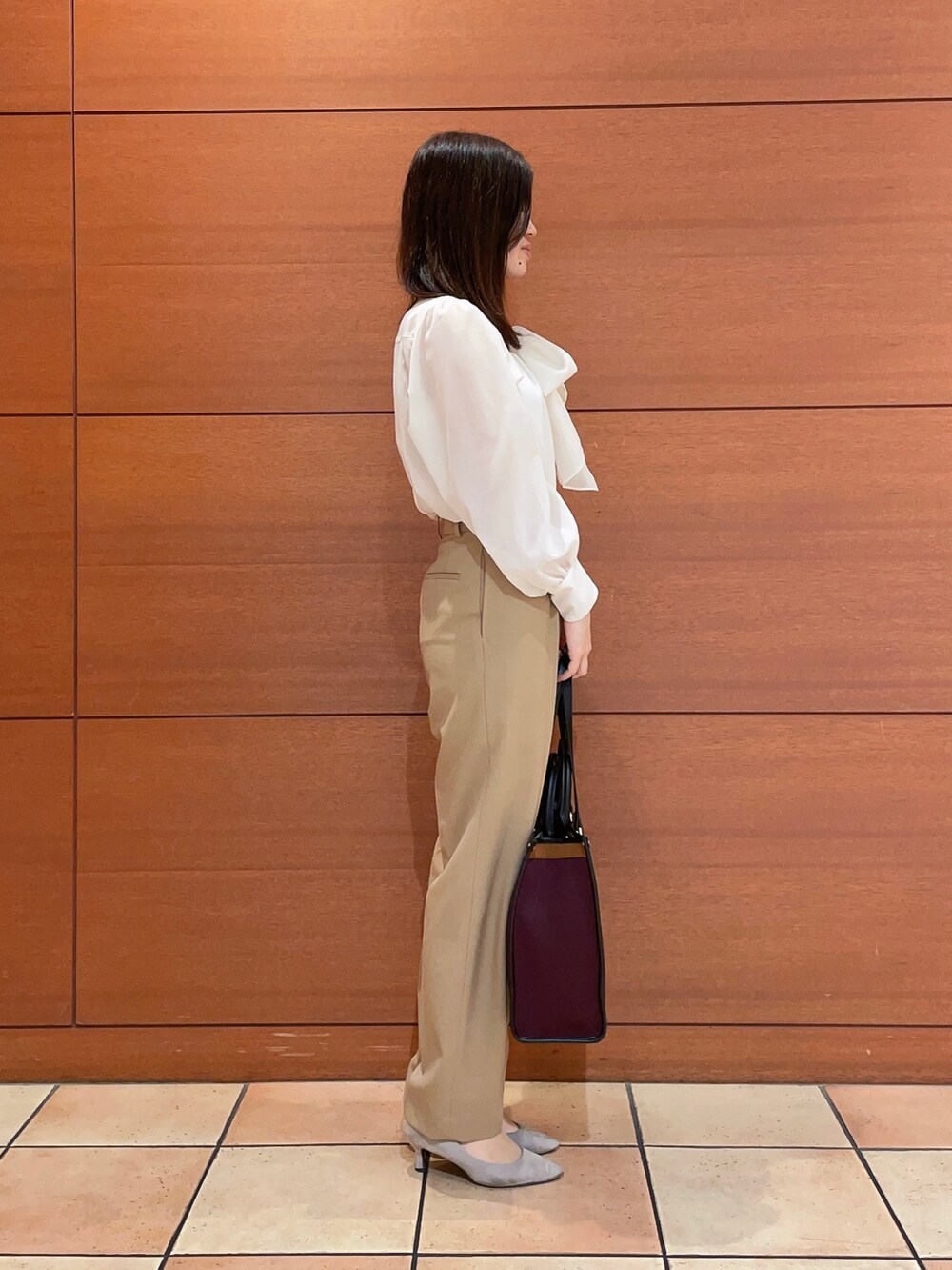 イエロー系のテーラードジャケット、イエロー系のスラックス、ホワイト系のシャツ/ブラウスを着用したレディースの秋コーディネートの7枚目の写真