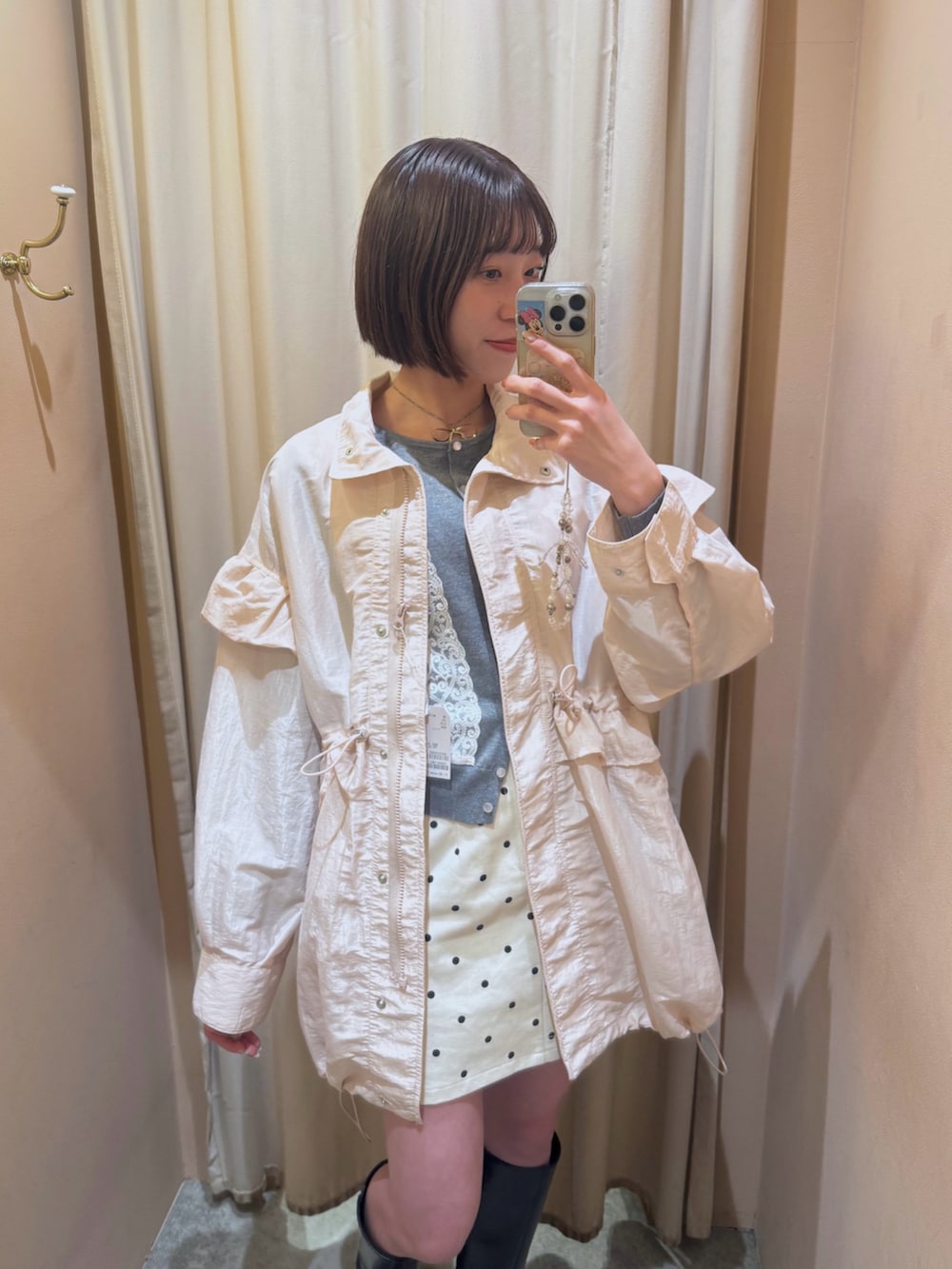 グレー系のカーディガン/ボレロ、ピンク系のブルゾン、ホワイト系のスカートを着用したレディースの冬コーディネートの2枚目の写真