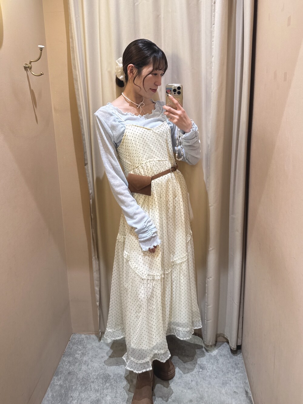 イエロー系のブーツ、ホワイト系のワンピース、ブルー系のTシャツ/カットソーを着用したレディースの春コーディネートの2枚目の写真