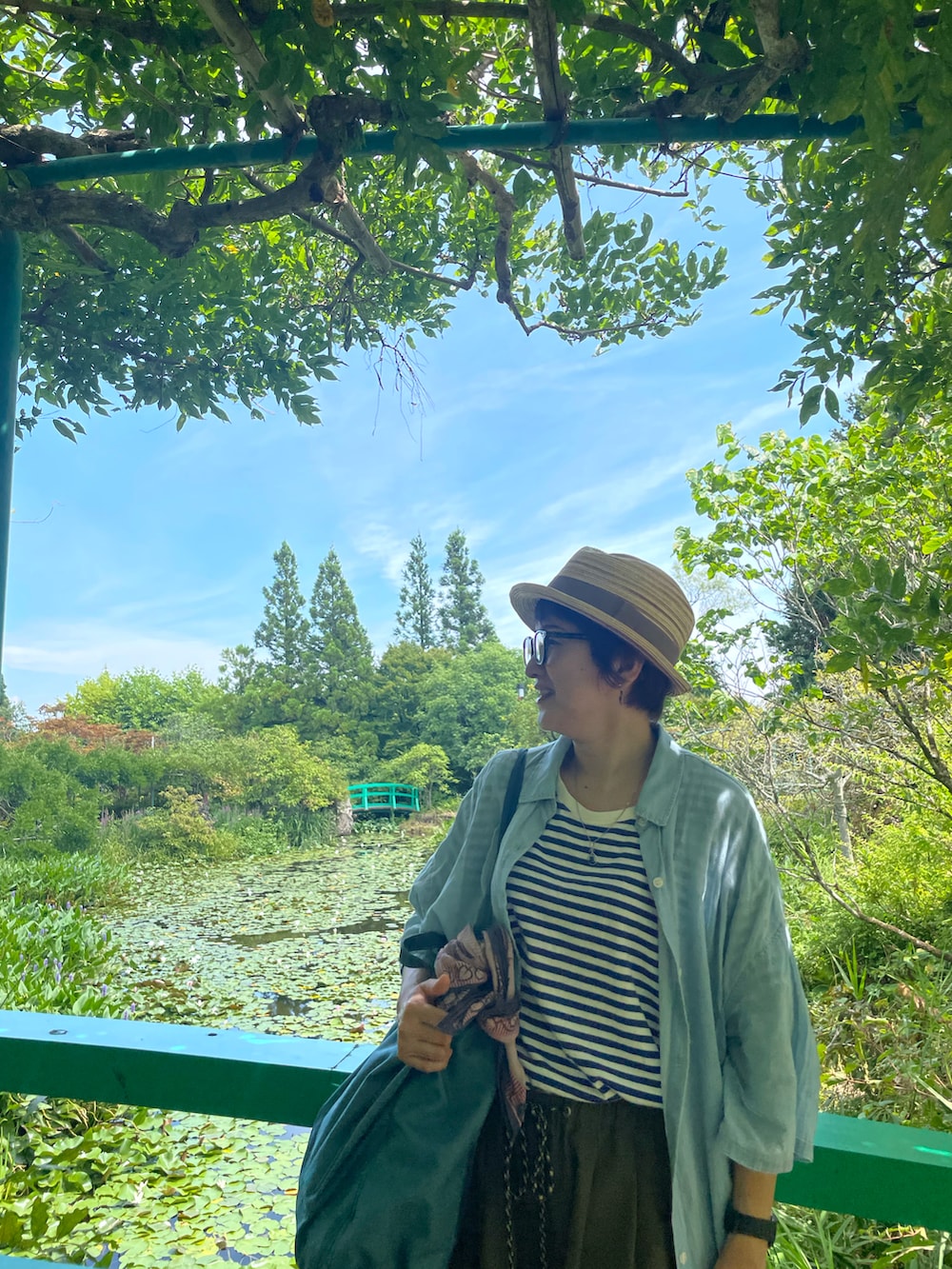 ブルー系のTシャツ/カットソー、グリーン系のその他パンツ、ブルー系のトートバッグを着用したレディースの秋コーディネートの4枚目の写真