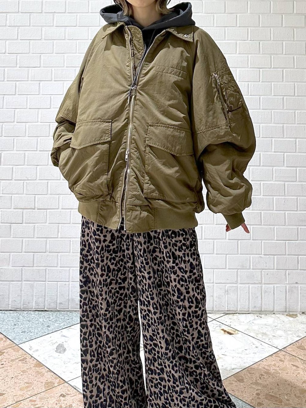 ブラック系のブーツ、グレー系のパーカー、ベージュ系のその他パンツを着用したレディースの冬コーディネートの9枚目の写真