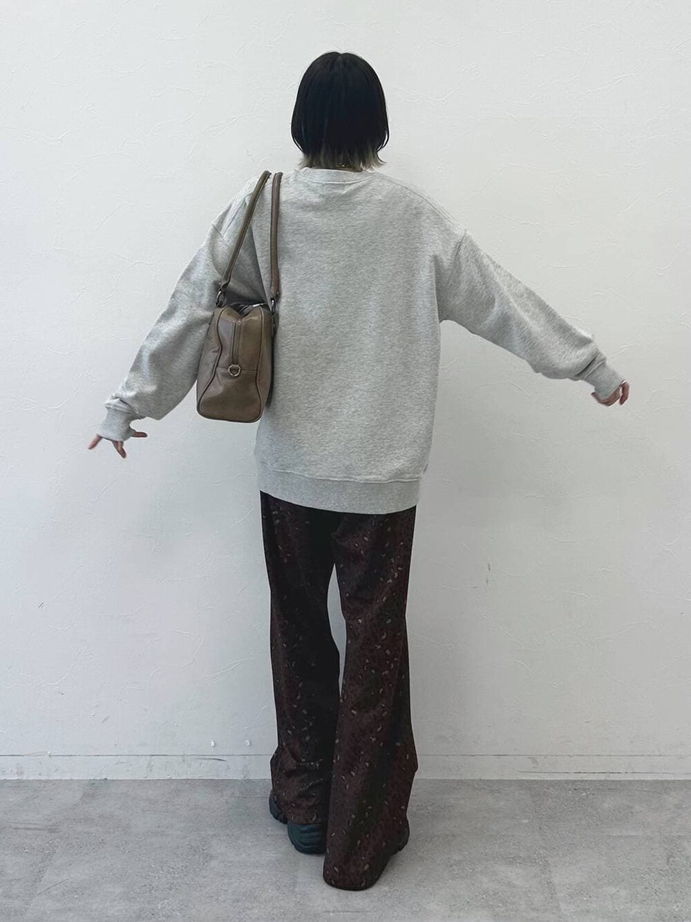 ブラック系のブーツ、ベージュ系のボストンバッグ、グレー系のスウェットを着用したレディースの冬コーディネートの6枚目の写真