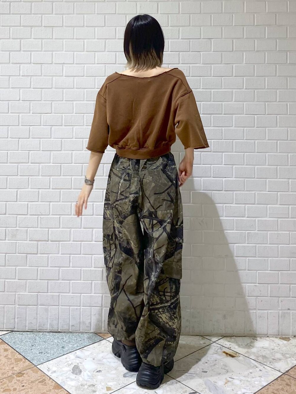 ブラウン系のブーツ、グリーン系のカーゴパンツ、ブラウン系のTシャツ/カットソーを着用したレディースの夏コーディネートの6枚目の写真