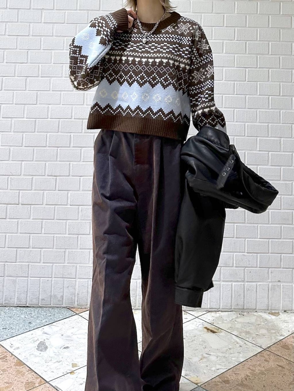 ブラック系のブーツ、ブラック系のブルゾン、ブルー系のデニムパンツを着用したレディースの冬コーディネートの8枚目の写真