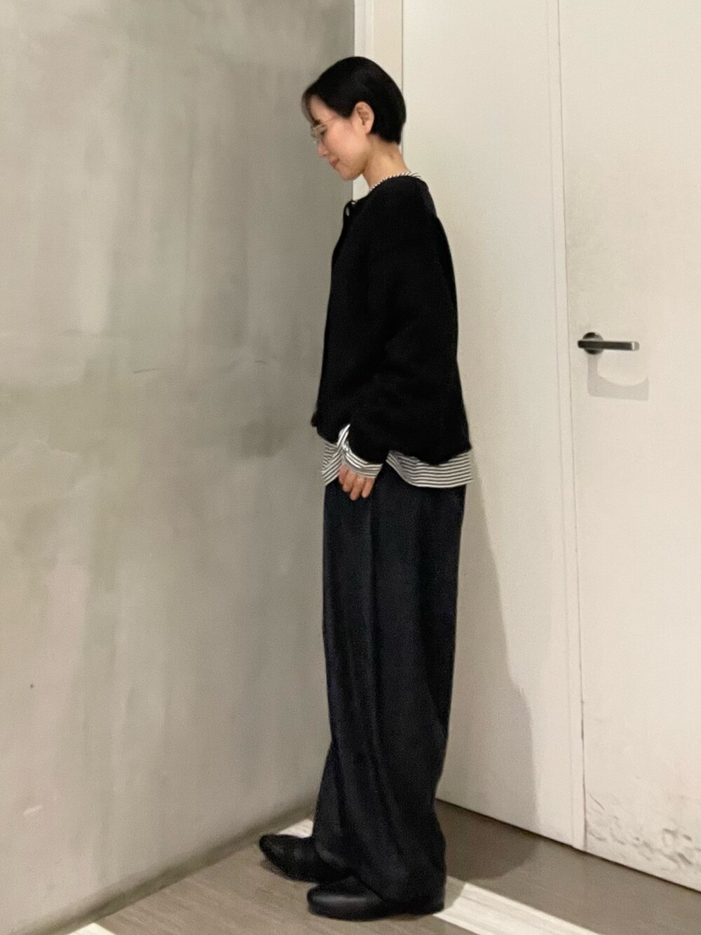 ブラック系のその他シューズ、ブルー系のデニムパンツ、ブラック系のカーディガン/ボレロを着用したレディースの冬コーディネートの2枚目の写真