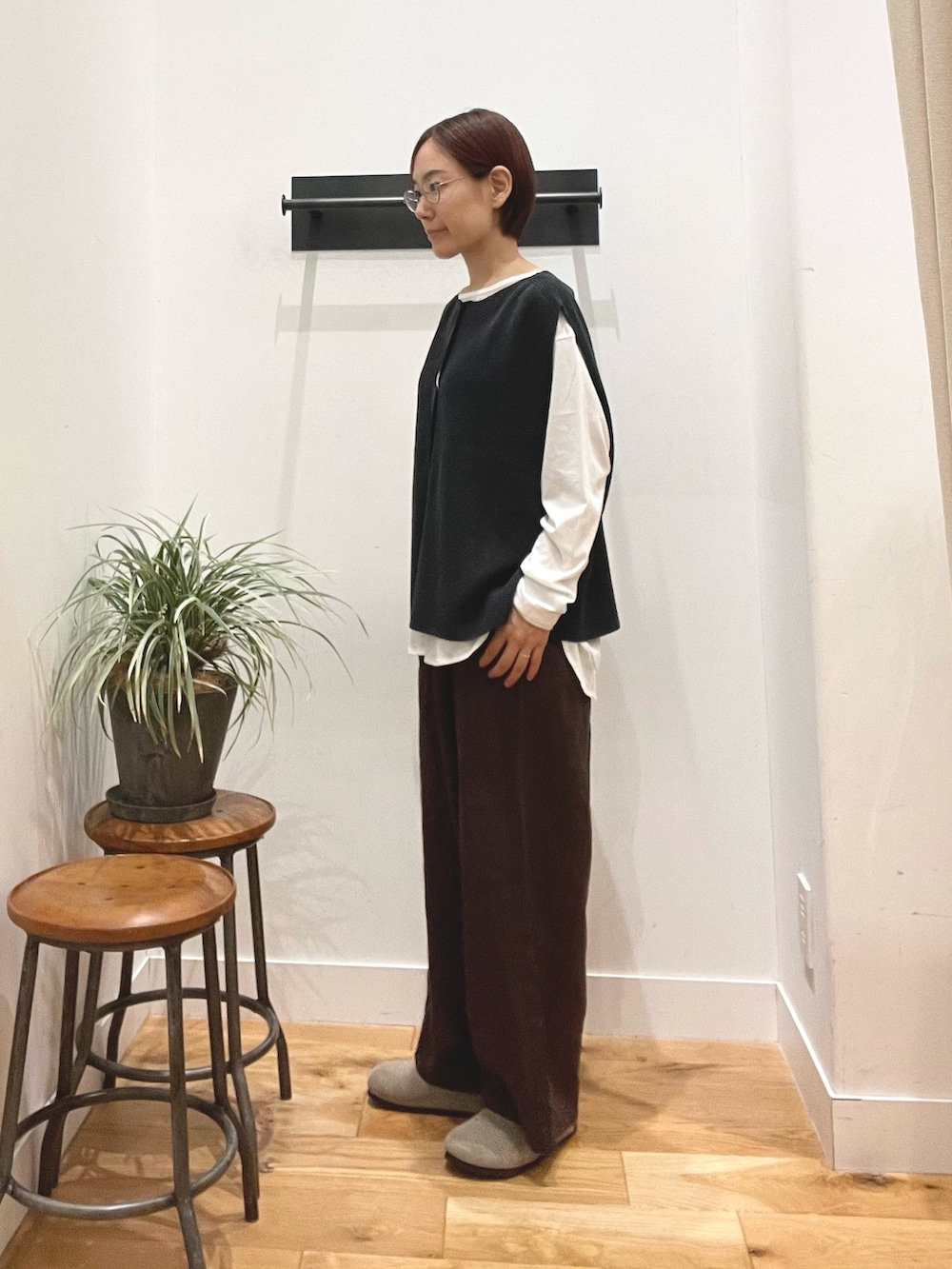 ベージュ系のその他シューズ、ブラウン系のその他パンツ、ブラック系のベストを着用したレディースの夏コーディネートの2枚目の写真