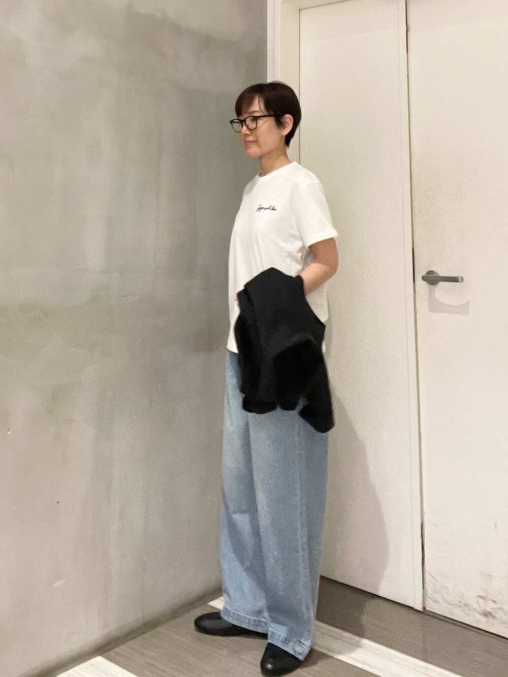 ブラック系のローファー、ホワイト系のTシャツ/カットソー、ブラック系のカバーオールを着用したレディースの春コーディネートの6枚目の写真