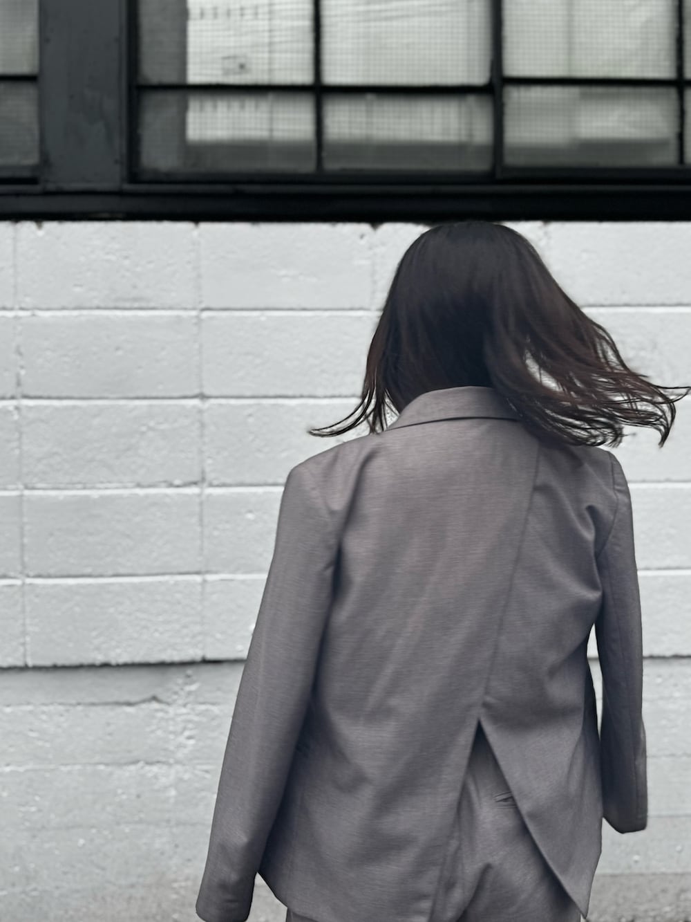 ブラック系のトップス、グレー系のジャケット/アウター、グレー系のパンツを着用したレディースの秋コーディネートの4枚目の写真