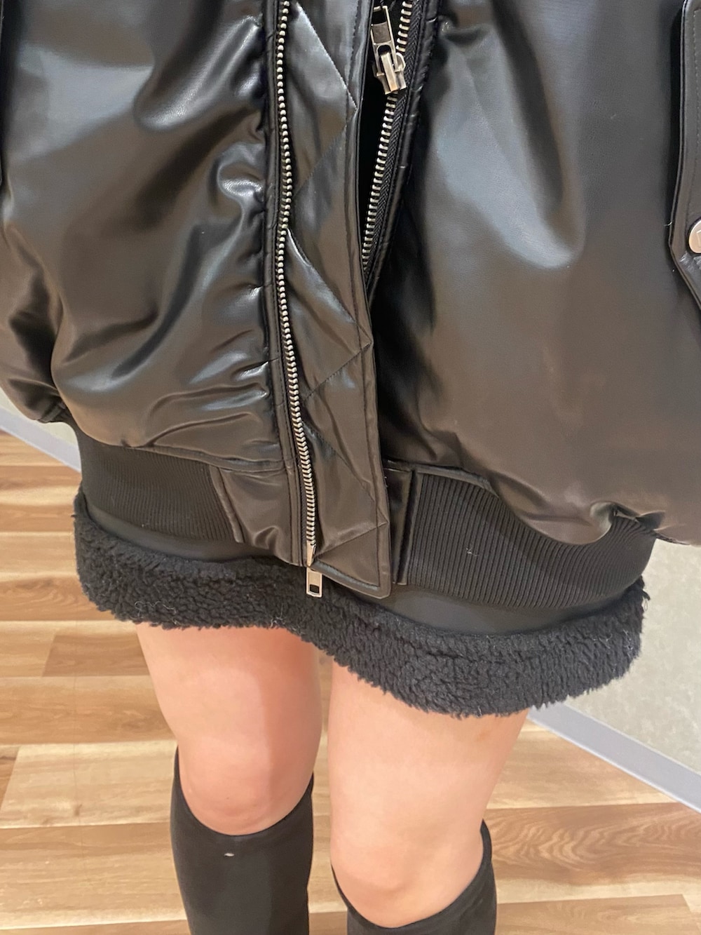 ブラック系のブルゾン、ブラック系のニット/セーター、ブラック系のスカートを着用したレディースの秋コーディネートの6枚目の写真