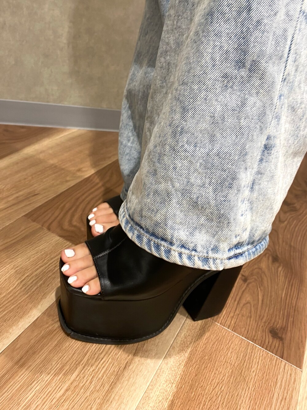 ブルー系のデニムパンツ、ブルー系のキャミソール、シルバー系のハンドバッグを着用したレディースの夏コーディネートの8枚目の写真