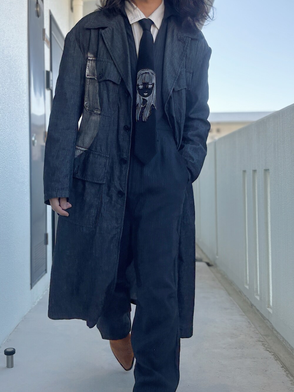 ブラック系のデニムジャケット、ブラック系のネクタイ、ブラック系のつなぎ/オールインワンを着用したメンズの冬コーディネートの4枚目の写真