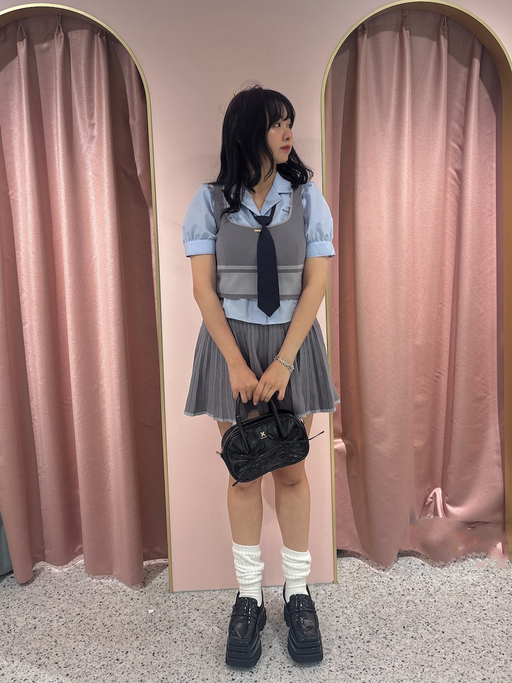 ブルー系のシャツ/ブラウス、グレー系のワンピース、ブラック系のショルダーバッグを着用したレディースの夏コーディネートの2枚目の写真