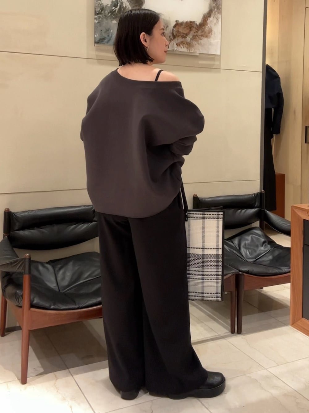 ブラウン系のTシャツ/カットソー、グレー系のデニムパンツ、ブラック系のサンダルを着用したレディースの春コーディネートの3枚目の写真