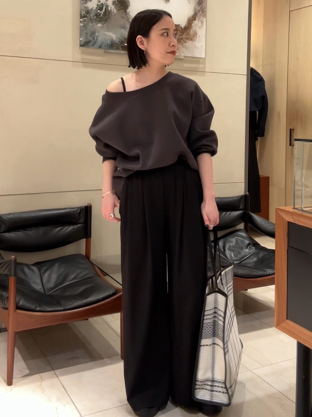 ブラウン系のTシャツ/カットソー、グレー系のデニムパンツ、ブラック系のサンダルを着用したレディースの春コーディネートの4枚目の写真
