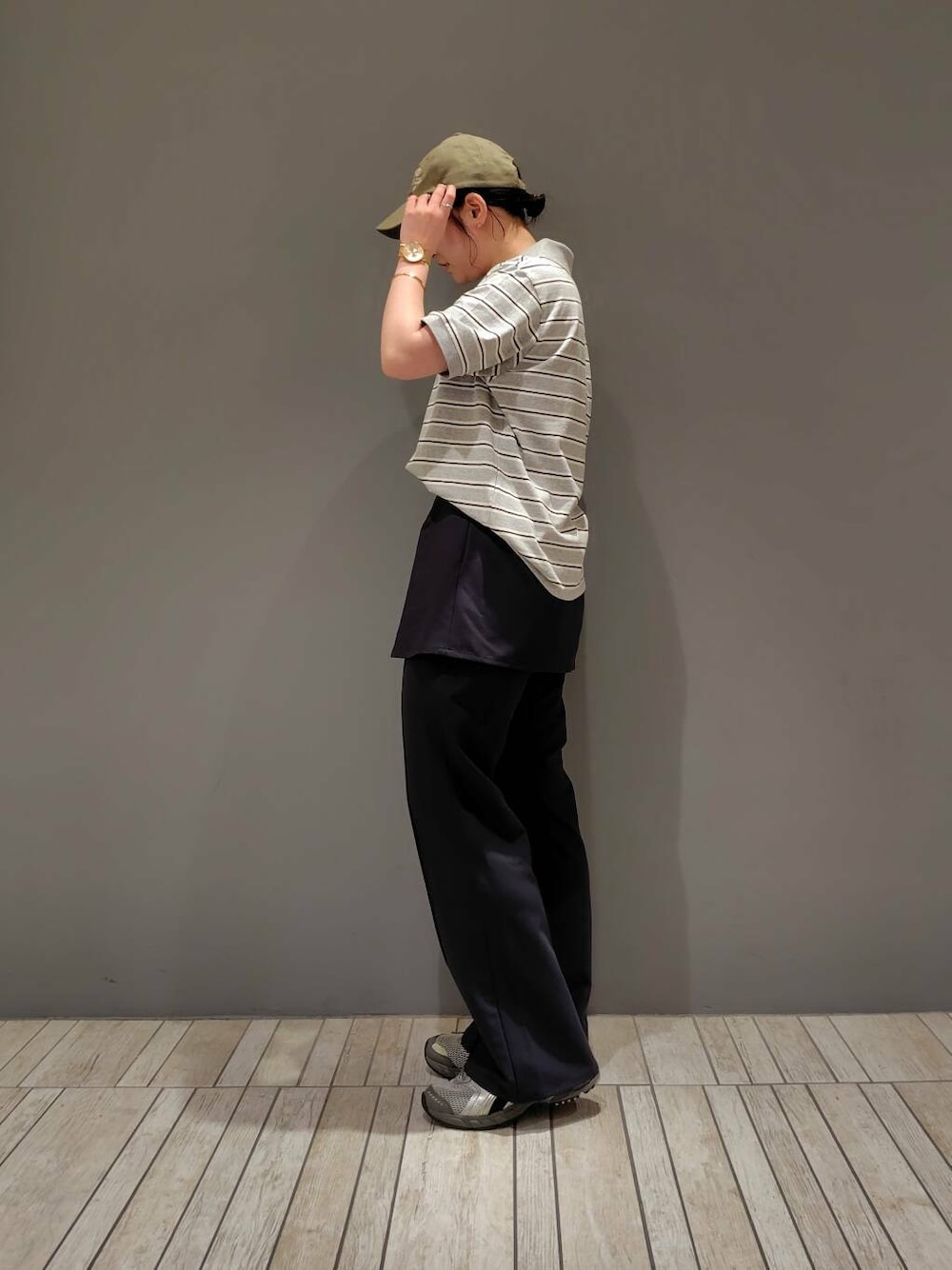 グレー系のその他パンツ、グレー系のTシャツ/カットソー、グリーン系のキャップを着用したレディースの夏コーディネートの2枚目の写真