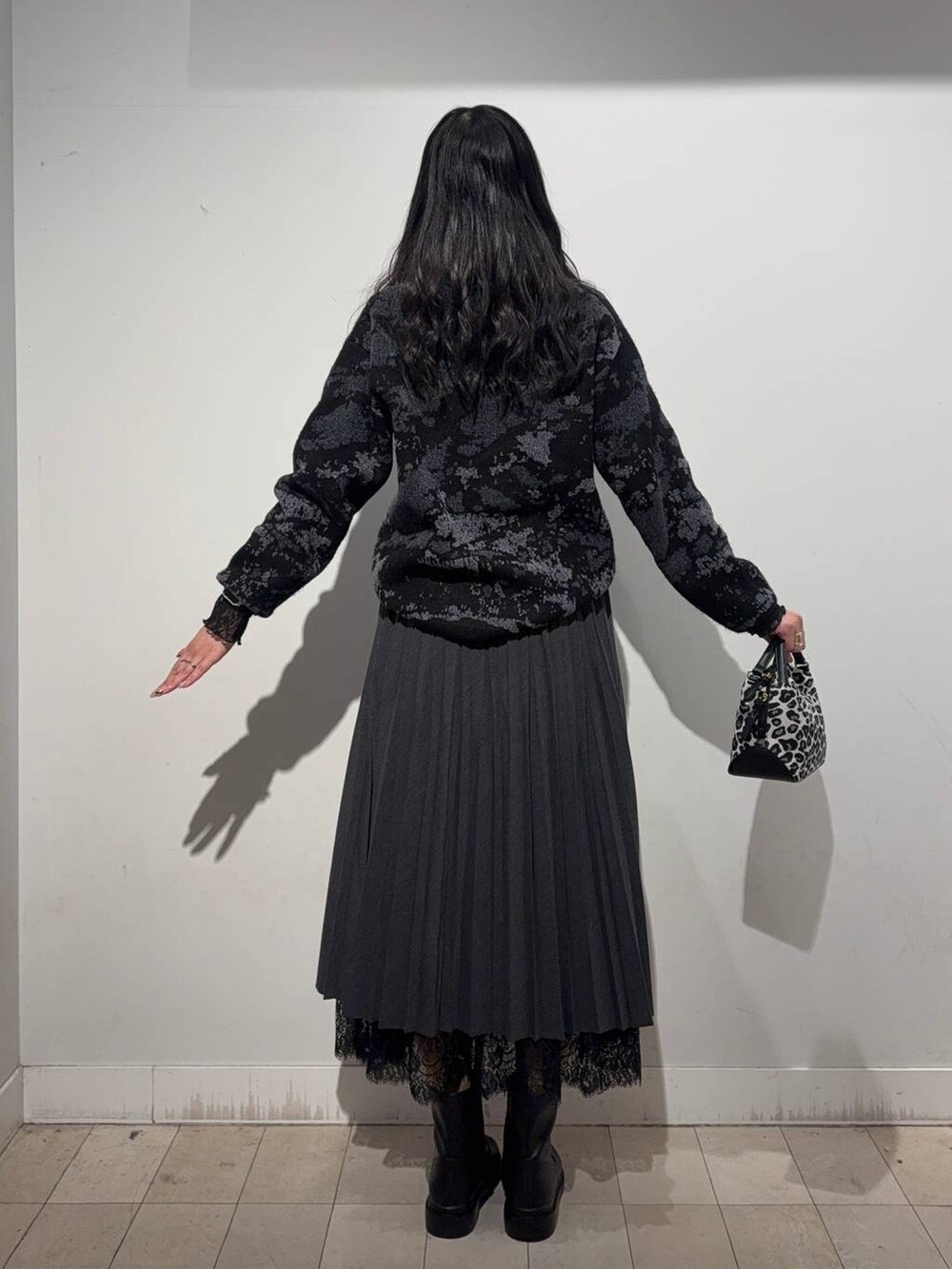 その他のショルダーバッグ、ブラウン系のワンピース、ブラック系のブーツを着用したレディースの冬コーディネートの3枚目の写真