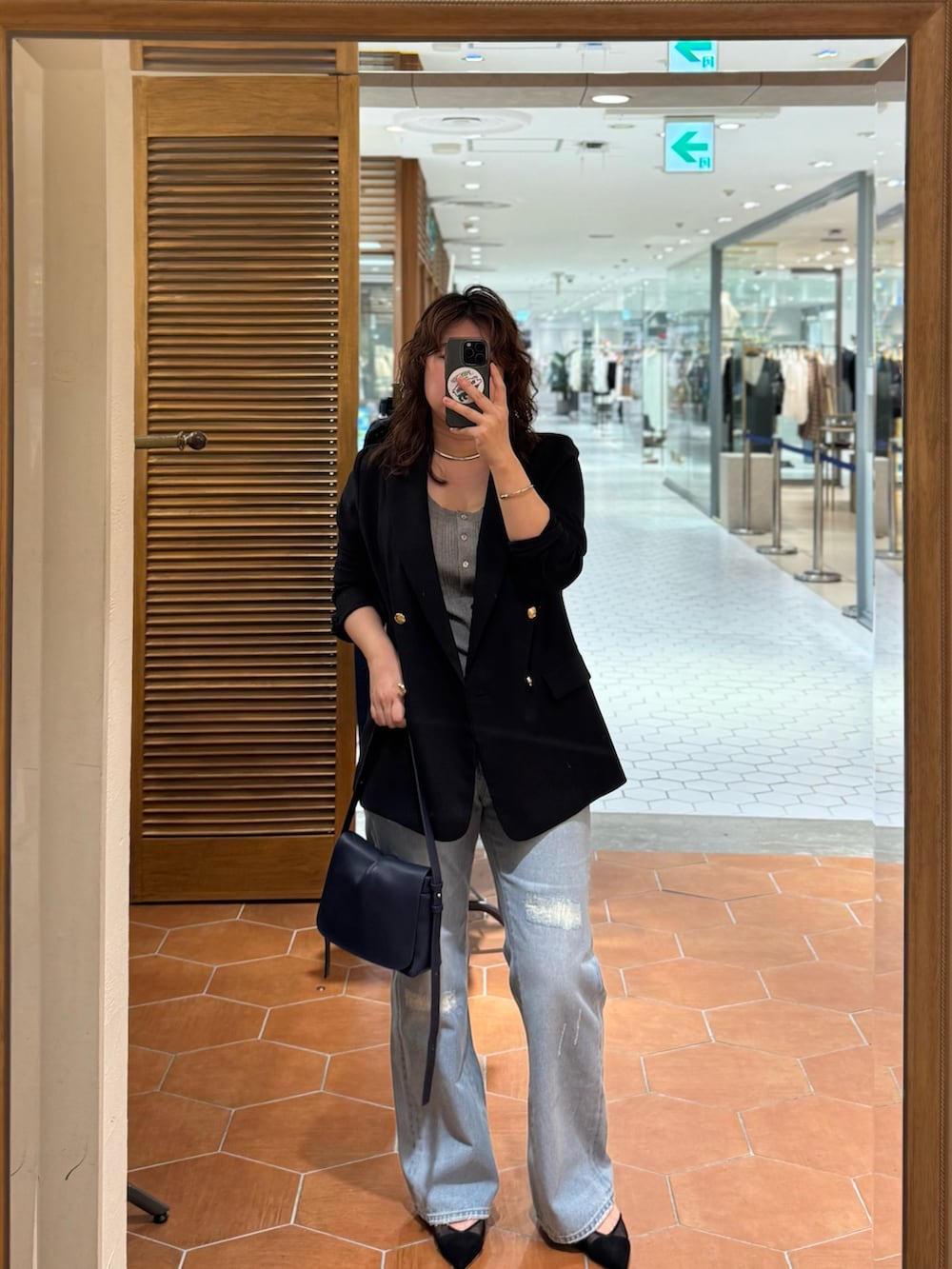 ブルー系のショルダーバッグ、ブルー系のデニムパンツ、ブルー系のテーラードジャケットを着用したレディースの夏コーディネートの2枚目の写真