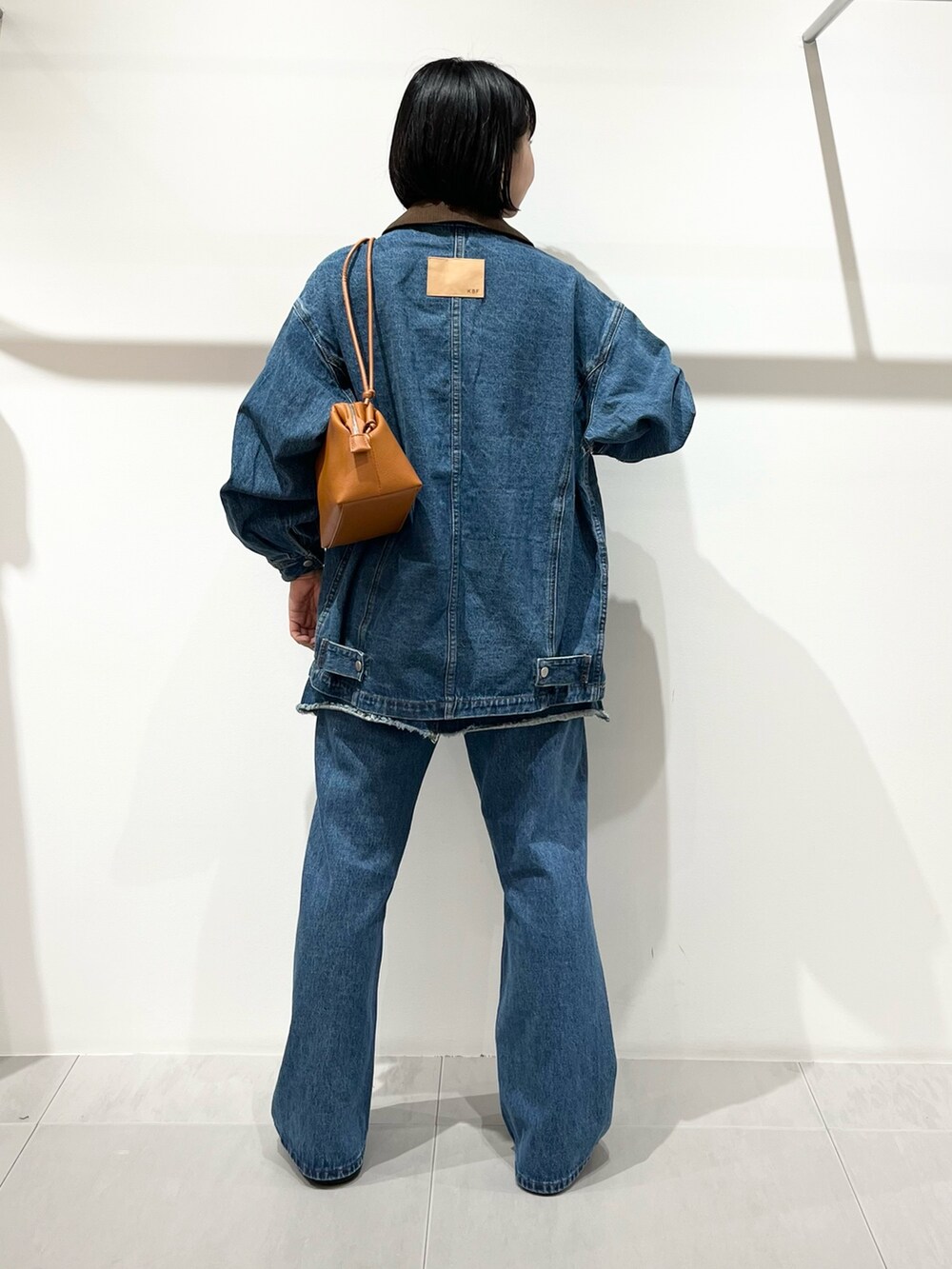ブルー系のブルゾン、ブルー系のスカート、ブルー系のデニムパンツを着用したレディースの夏コーディネートの3枚目の写真