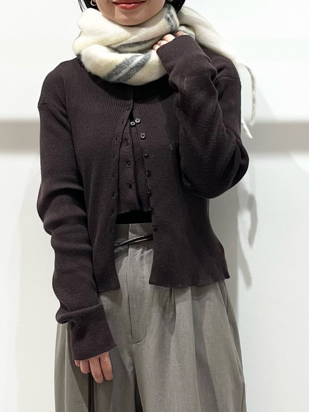 ブラウン系のニット/セーター、グレー系のその他パンツ、ブラック系のその他シューズを着用したレディースの冬コーディネートの6枚目の写真
