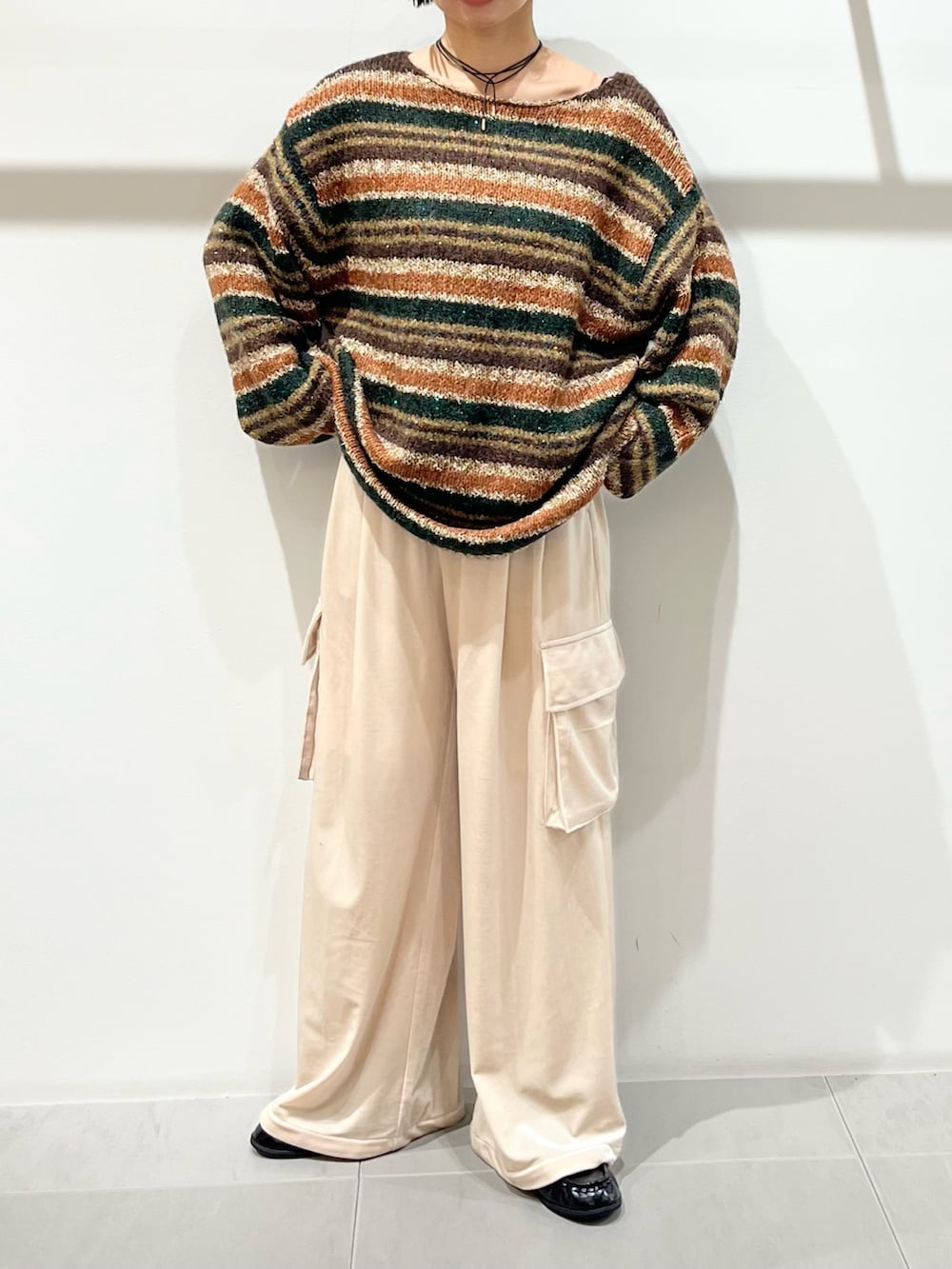 ブラウン系のニット/セーター、パープル系のその他パンツ、ブラック系のその他シューズを着用したレディースの秋コーディネートの6枚目の写真