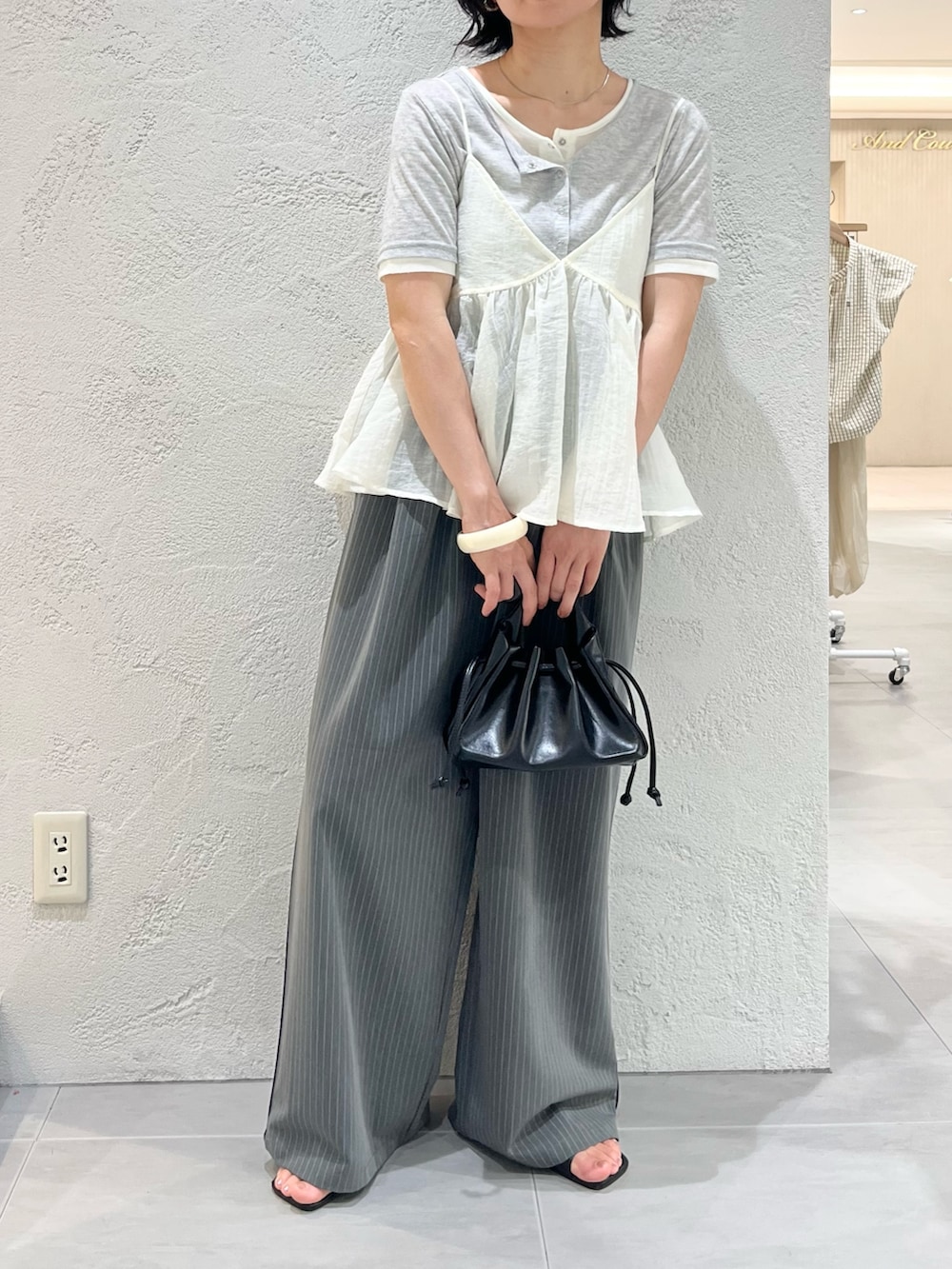 グレー系のTシャツ/カットソー、ホワイト系のその他トップス、ブラック系のサンダルを着用したレディースの夏コーディネートの6枚目の写真