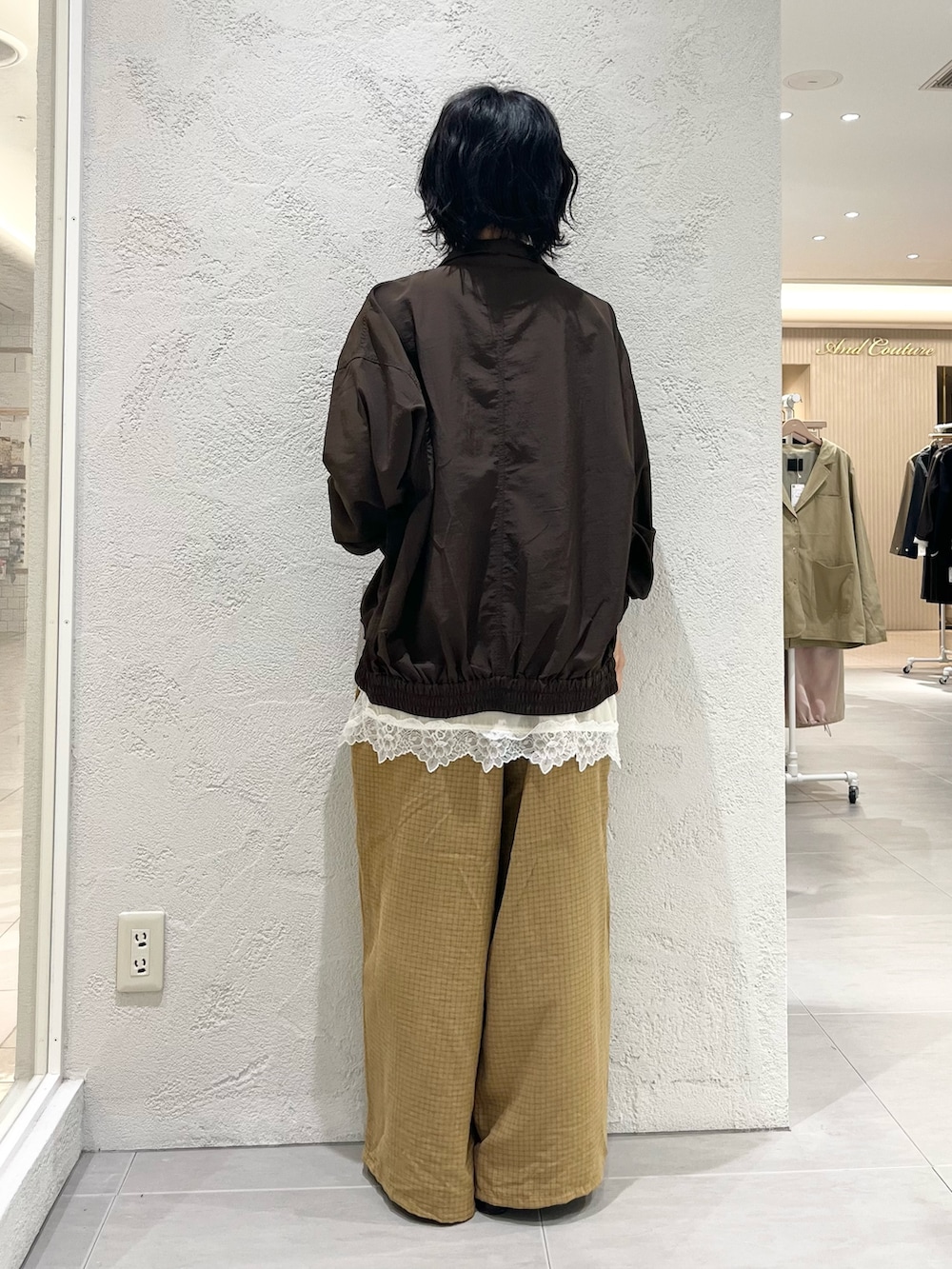 ブラック系のサンダル、イエロー系のその他パンツ、ブラウン系のナイロンジャケットを着用したレディースの秋コーディネートの3枚目の写真