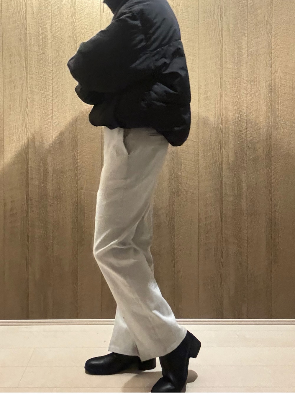 ホワイト系のデニムパンツ、ブラック系のブーツ、ブラック系のダウンジャケット/コートを着用したメンズの冬コーディネートの2枚目の写真