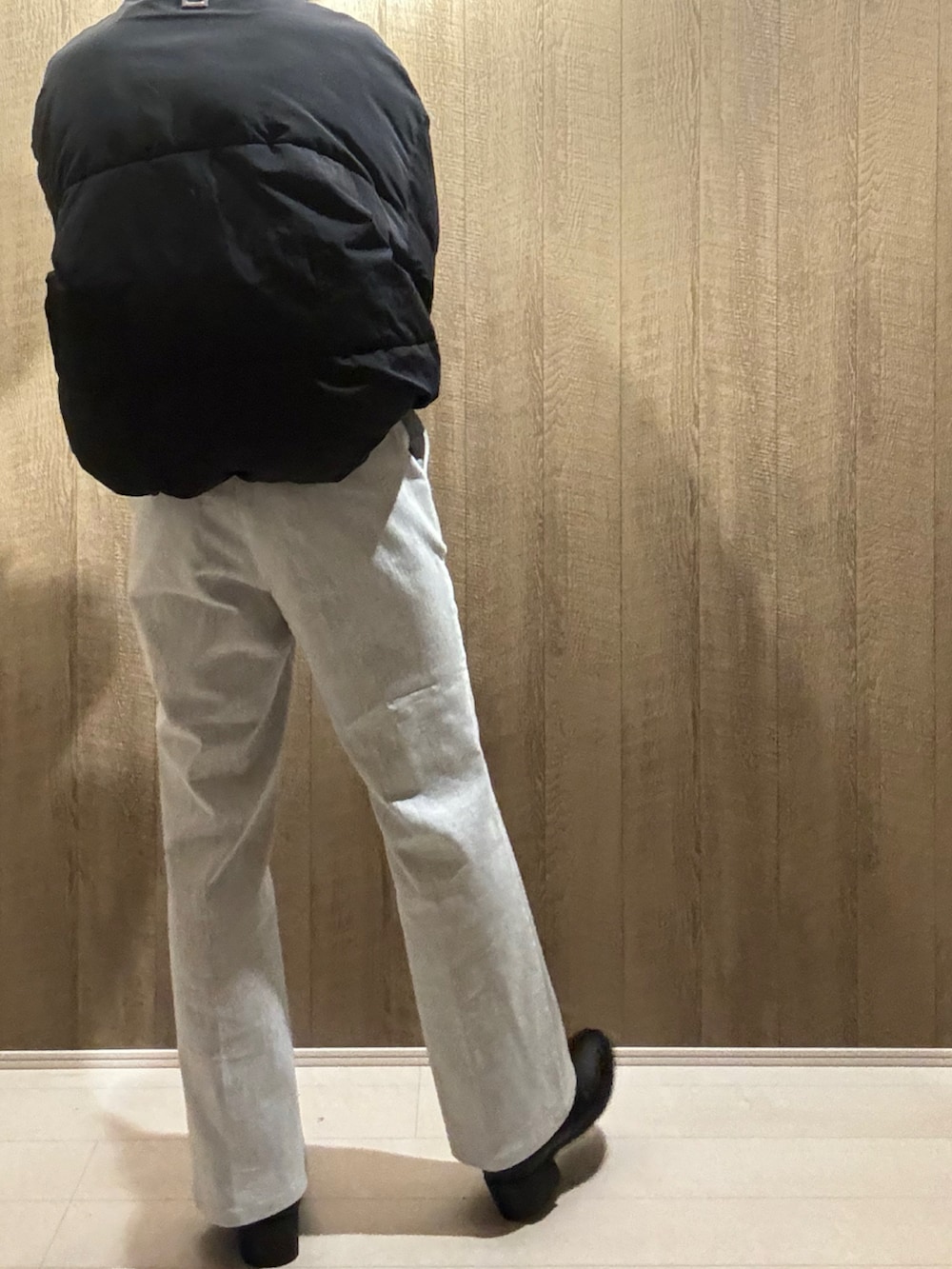 ホワイト系のデニムパンツ、ブラック系のブーツ、ブラック系のダウンジャケット/コートを着用したメンズの冬コーディネートの3枚目の写真