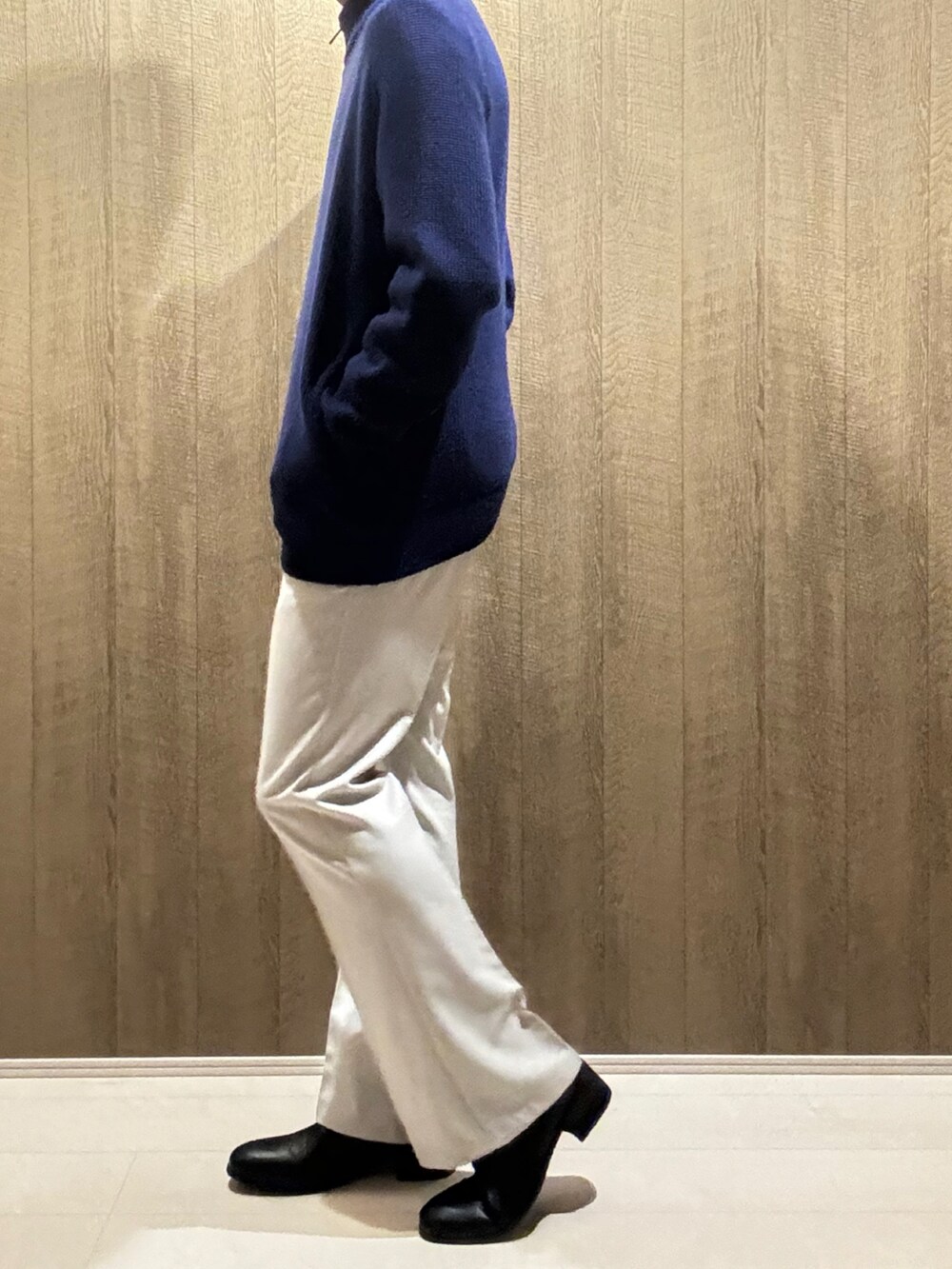 ブルー系のニット/セーター、ブラック系のブーツを着用したメンズの秋コーディネートの2枚目の写真