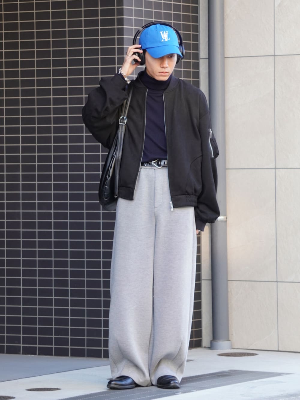 グレー系のスウェットパンツ、ブラック系のブーツ、ブラック系のTシャツ/カットソーを着用したメンズの冬コーディネートの2枚目の写真