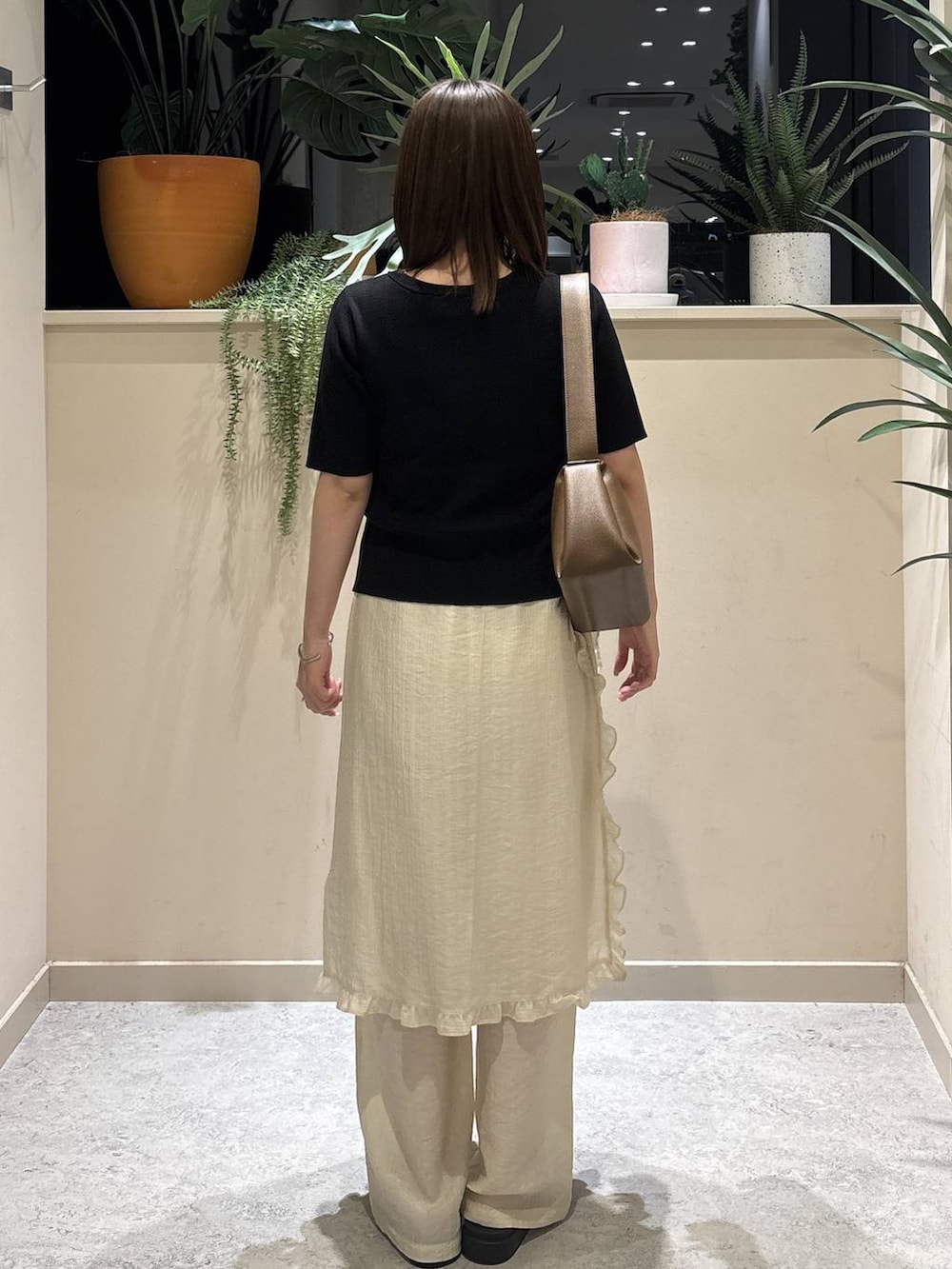 ブラック系のサンダル、ブラウン系のショルダーバッグ、ホワイト系のその他パンツを着用したレディースの春コーディネートの3枚目の写真