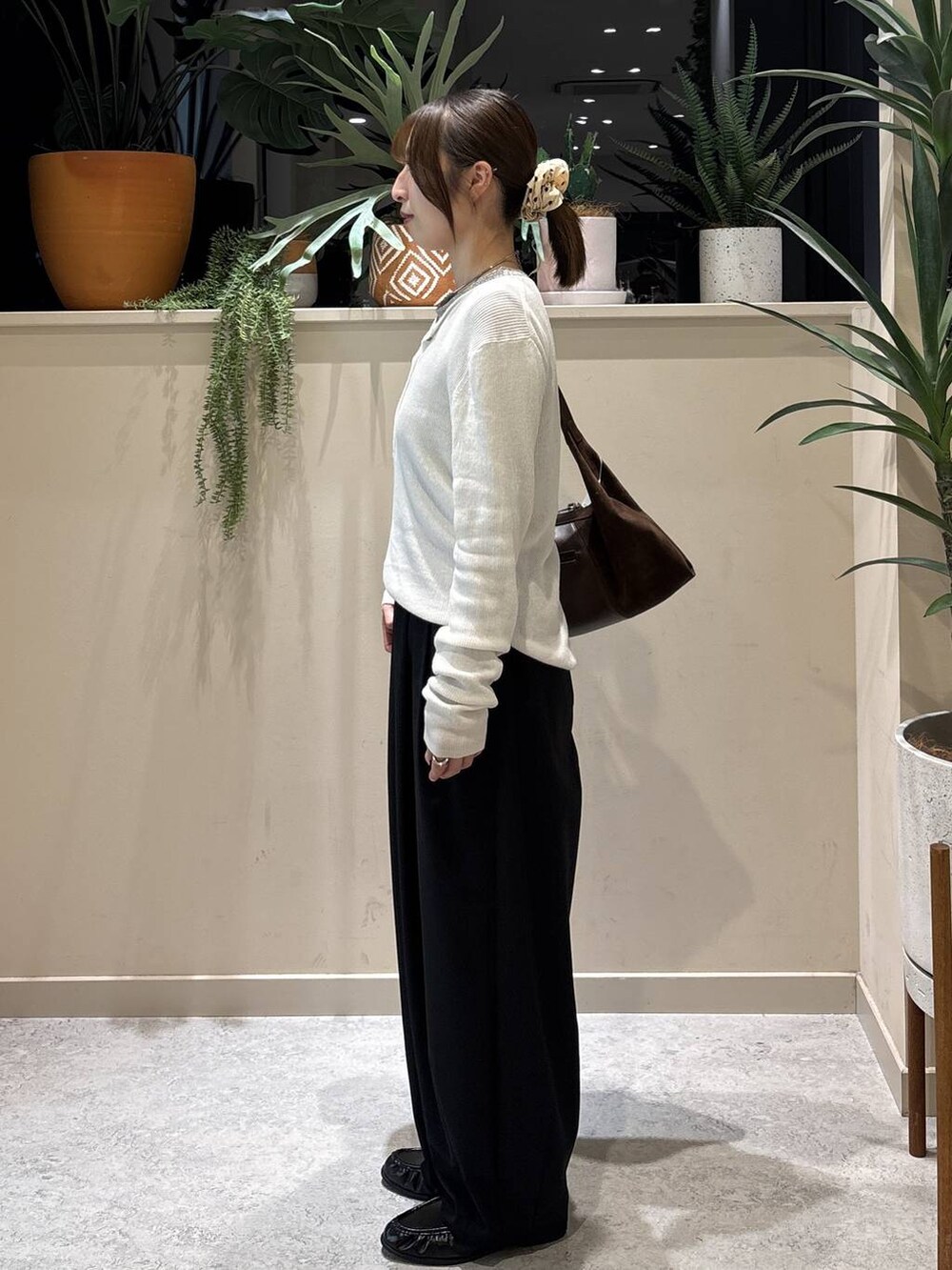 ブラック系のその他パンツ、ホワイト系のニット/セーター、ブラック系のローファーを着用したレディースの冬コーディネートの2枚目の写真