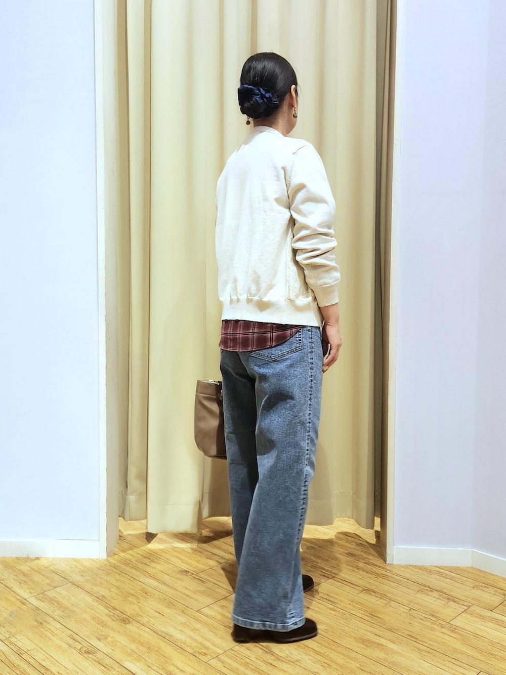 レッド系のシャツ/ブラウス、ホワイト系のカーディガン/ボレロ、ブルー系のデニムパンツを着用したレディースの秋コーディネートの5枚目の写真