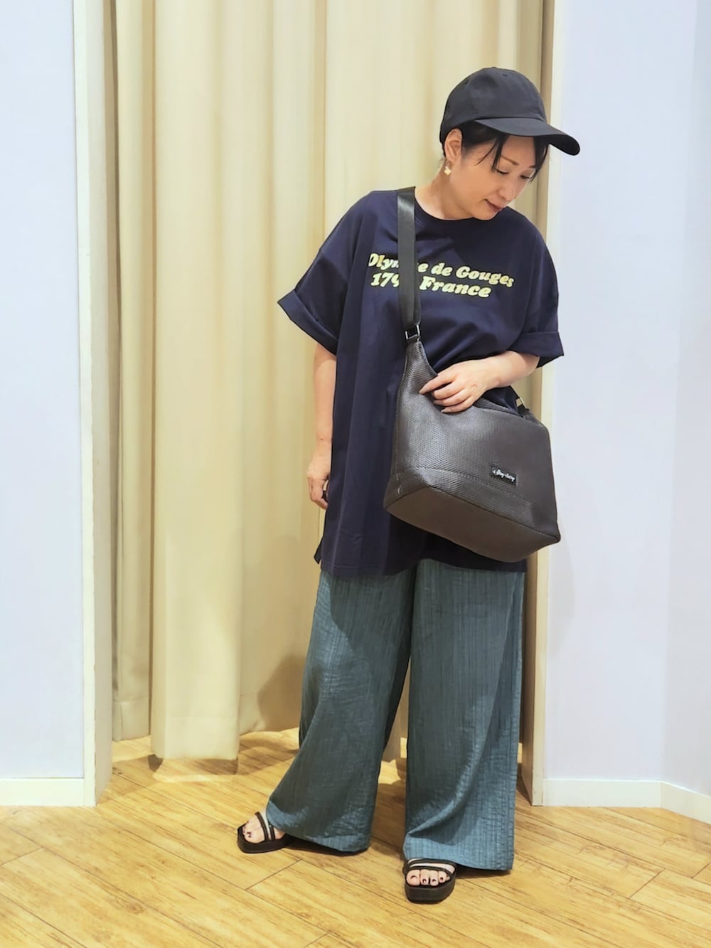 ブラック系のサンダル、グレー系のショルダーバッグ、ブルー系のTシャツ/カットソーを着用した夏コーディネートの2枚目の写真