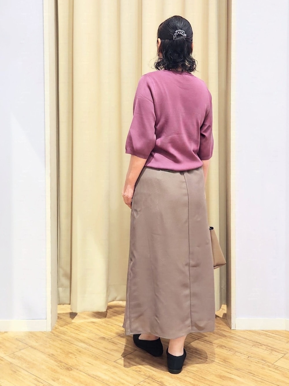 パープル系のニット/セーター、ブラウン系のスカート、ブラック系のパンプスを着用したレディースの夏コーディネートの5枚目の写真