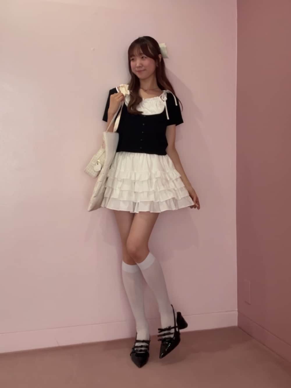 ブラック系のパンプス、ブラック系のTシャツ/カットソー、ホワイト系のトートバッグを着用したレディースの夏コーディネートの3枚目の写真