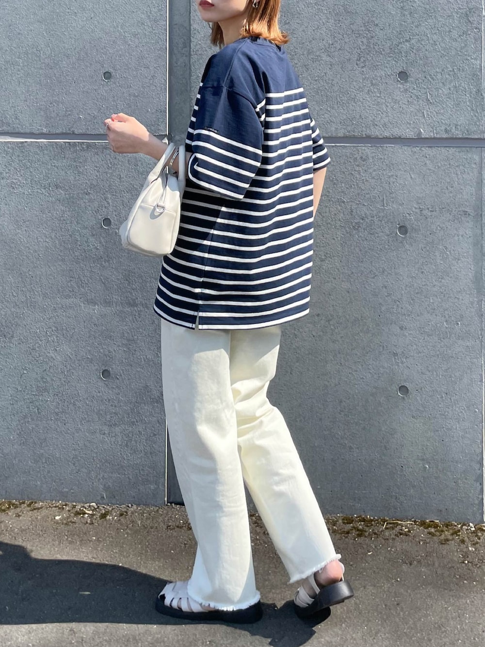 ブルー系のTシャツ/カットソー、ホワイト系のデニムパンツを着用したレディースの夏コーディネートの2枚目の写真