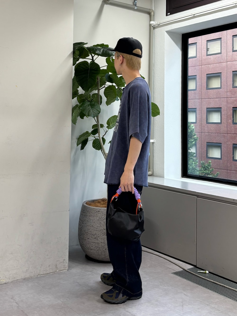 ブルー系のTシャツ/カットソー、ブラック系のトートバッグ、ブラック系のキャップを着用したメンズの夏コーディネートの2枚目の写真