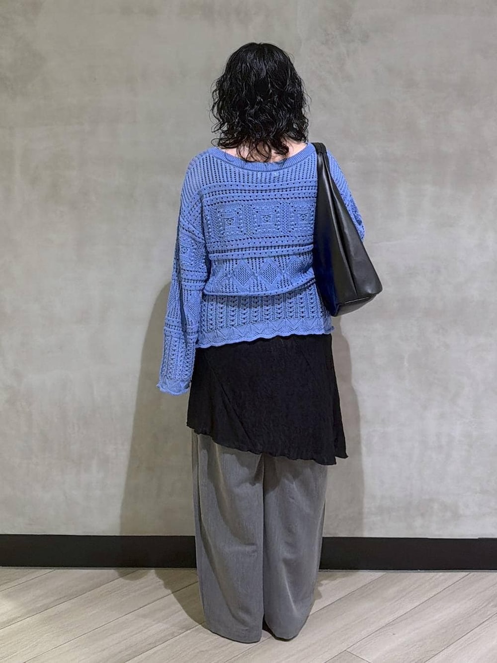 ブラック系のサンダル、ブラック系のトートバッグ、ブラック系のチュニックを着用したレディースの春コーディネートの3枚目の写真