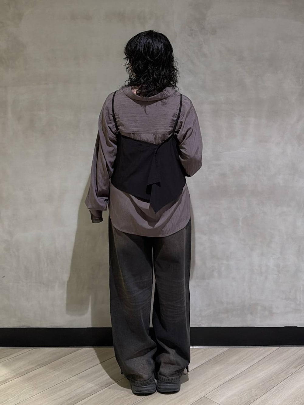 ブラック系のスニーカー、ブラック系のデニムパンツ、ブラック系のTシャツ/カットソーを着用したレディースの秋コーディネートの3枚目の写真