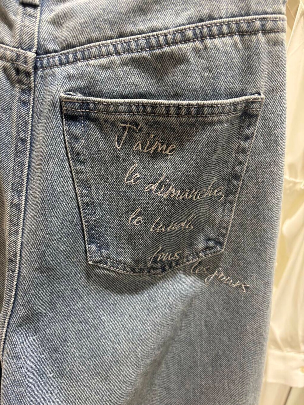 グリーン系のトートバッグ、ブルー系のデニムパンツ、ホワイト系のシャツ/ブラウスを着用したレディースの春コーディネートの6枚目の写真