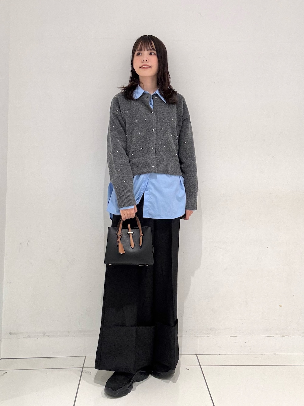 グレー系のカーディガン/ボレロ、ブルー系のシャツ/ブラウス、ブラック系のその他パンツを着用したレディースの秋コーディネートの4枚目の写真