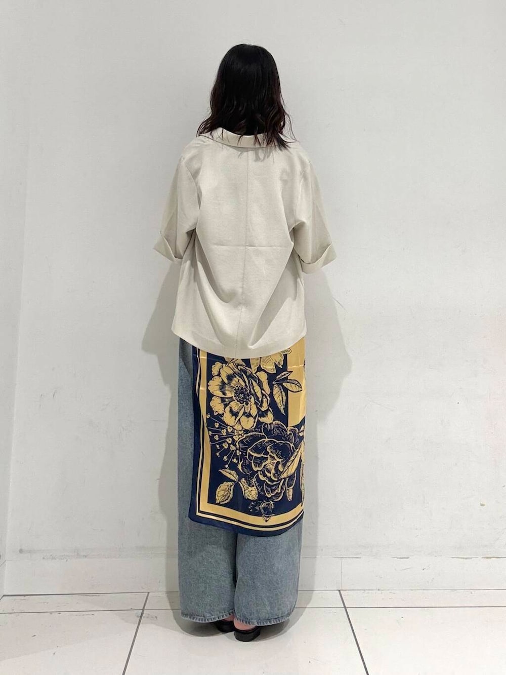 ブラック系のサンダル、ブラック系のトートバッグ、ブルー系のデニムパンツを着用したレディースの夏コーディネートの3枚目の写真