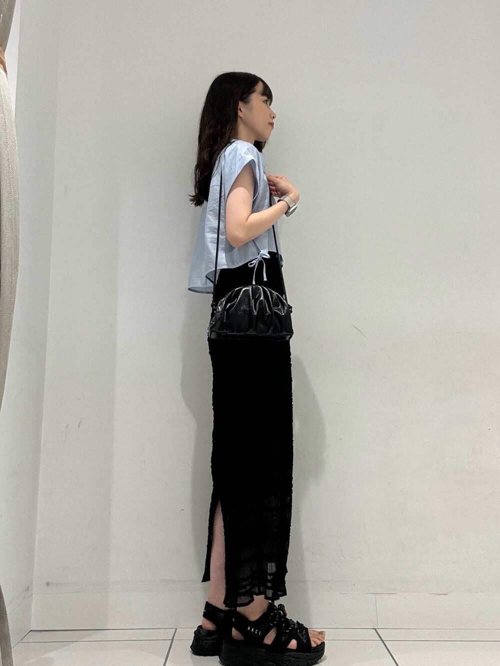 ブルー系のシャツ/ブラウス、ブラック系のスカート、ブラック系のショルダーバッグを着用したレディースの夏コーディネートの4枚目の写真